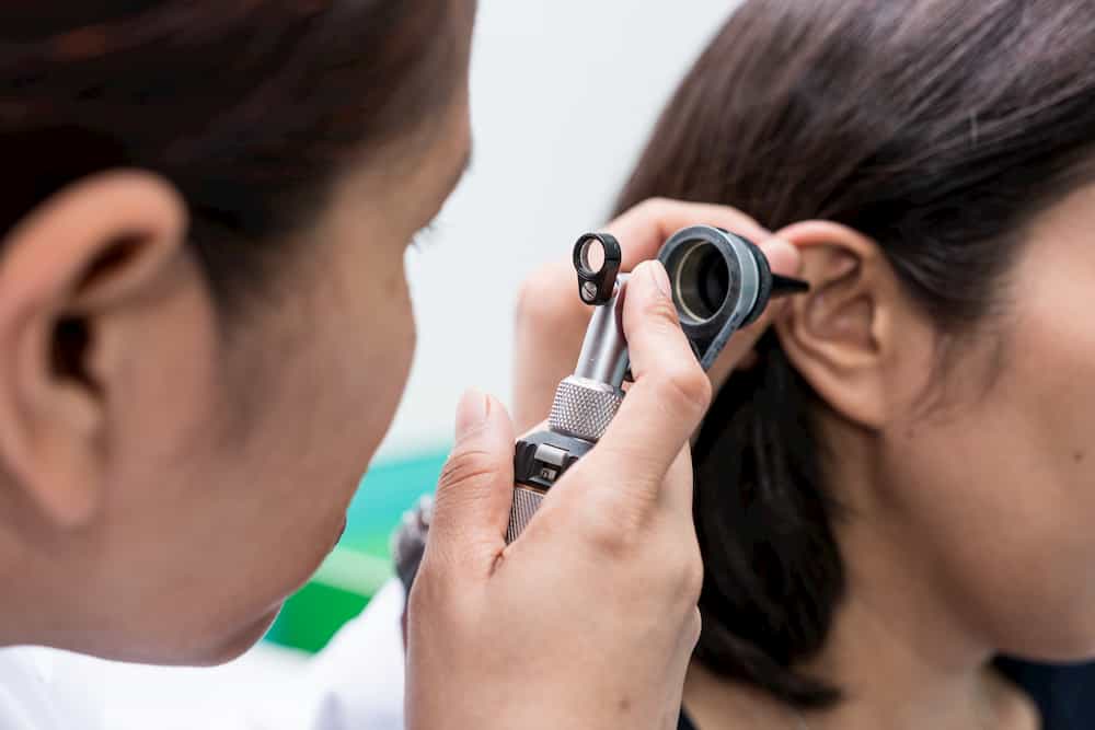 ear doctor checking ears of a patient 